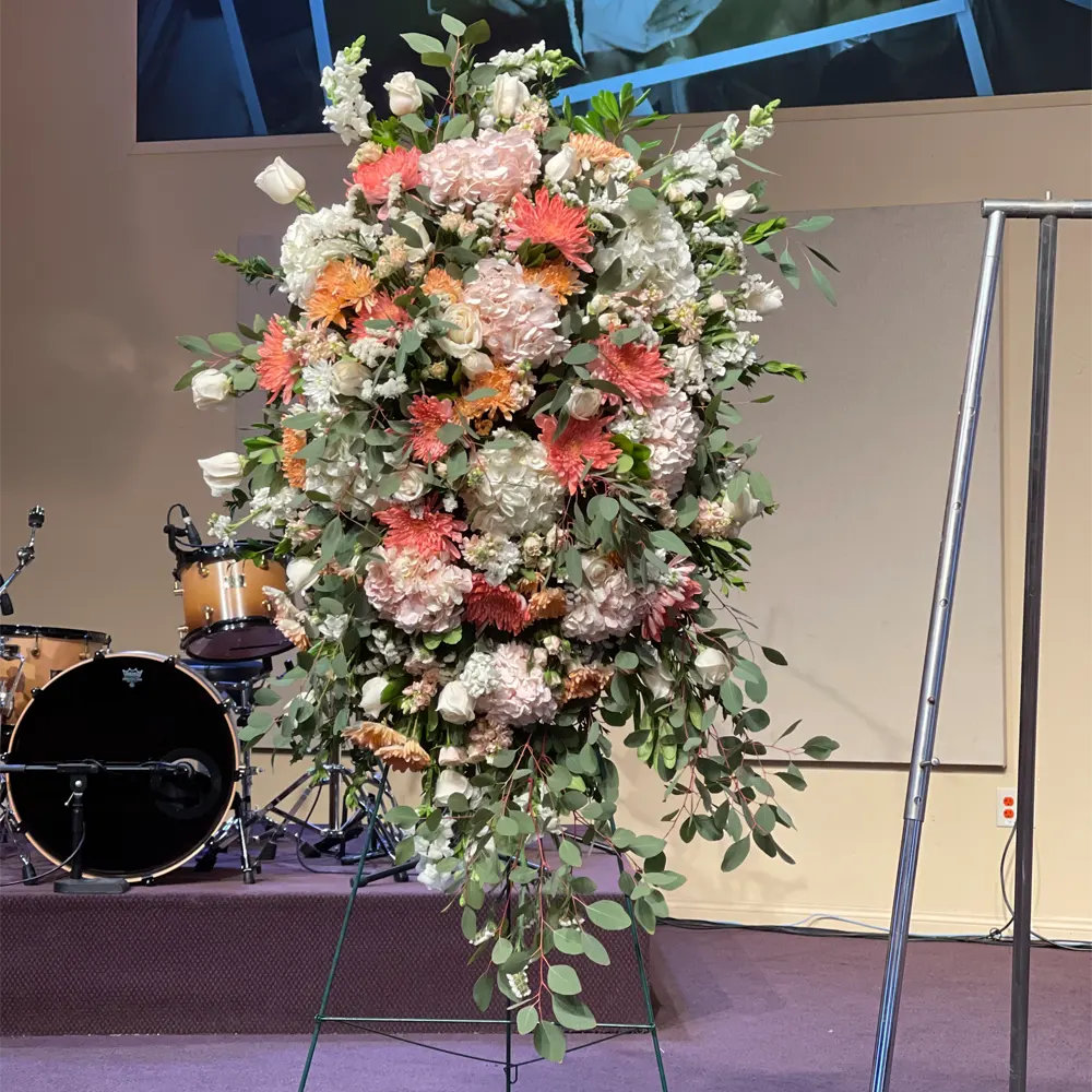 Elegant wedding centerpiece with peach and cream flowers