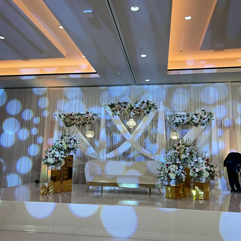 Modern illuminated wedding stage with floral arrangements
