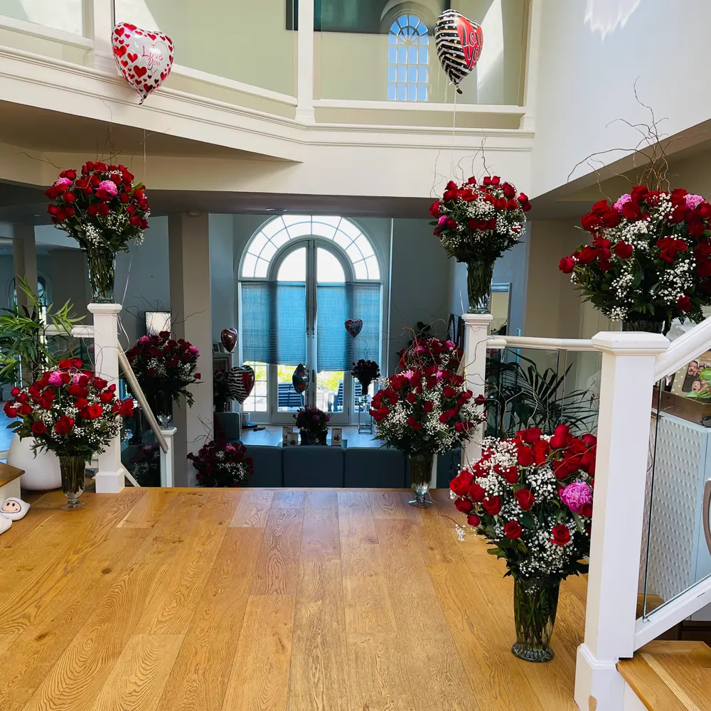 Grand staircase decorated with cascading red roses
