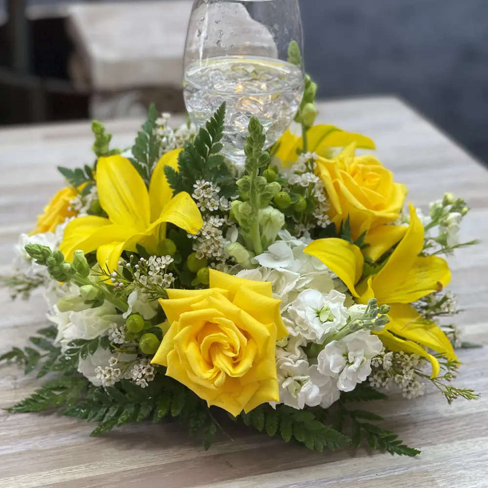 Vibrant yellow and white rose table centerpiece