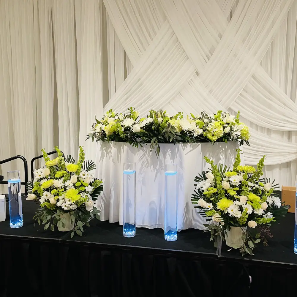 Sweetheart table with lush green and white floral runner