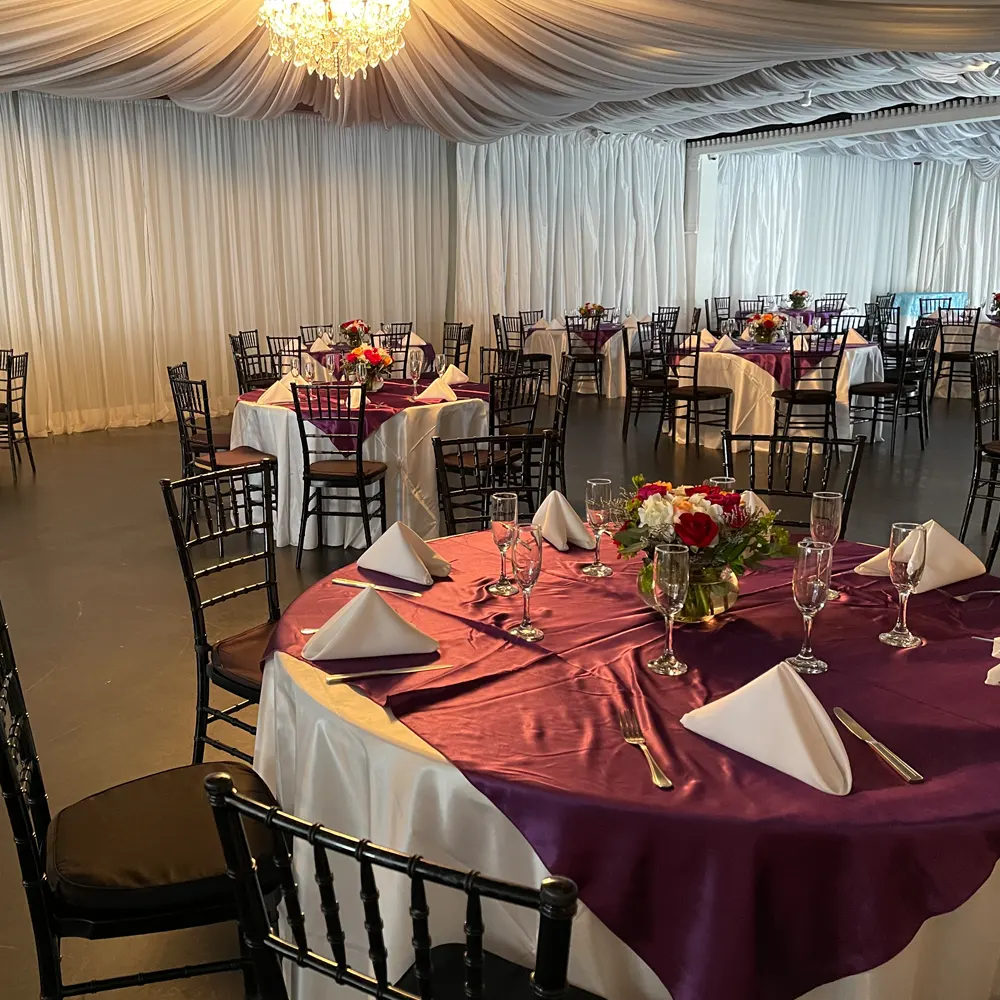 Reception room with round dining tables and floral decor