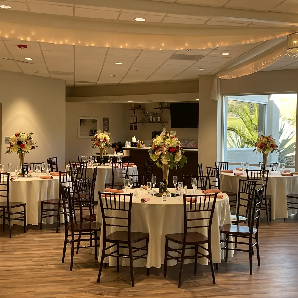 Indoor reception tables with warm ambient lighting and centerpieces