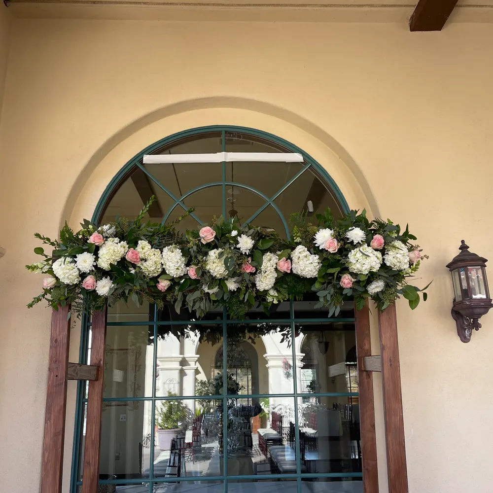 Floral archway over wedding entrance doorway