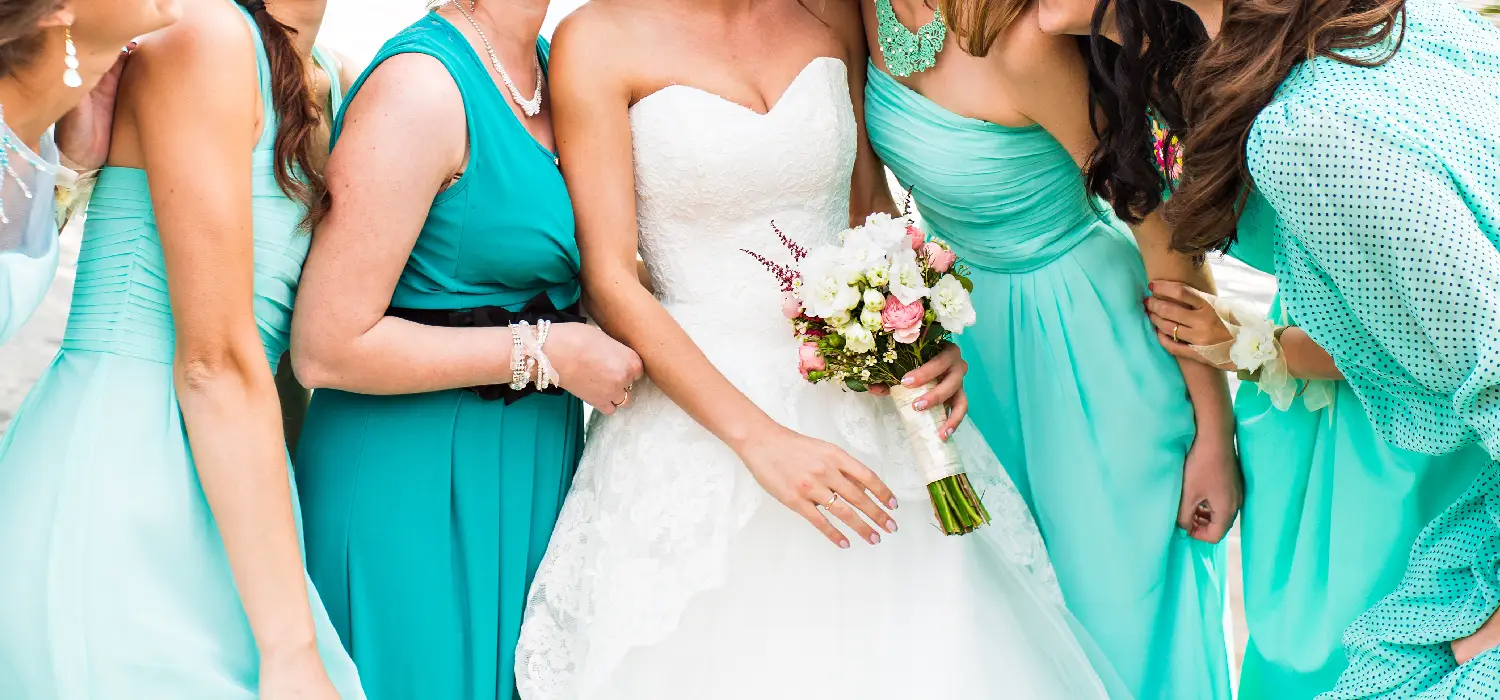 Bride with bridesmaids holding elegant wedding flower bouquets